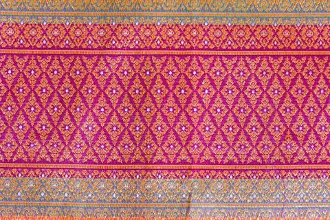 The image of the red Thai silk pattern that is woven in Thailand. Stock Photos