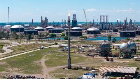 Image of a refinery flare with a controlled flame burning off excess natural gas Stock Photos