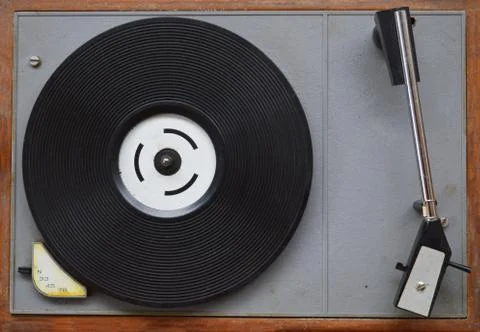 Image of a retro transistor gramaphone with turn table and tonearm in view. A Stock Photos