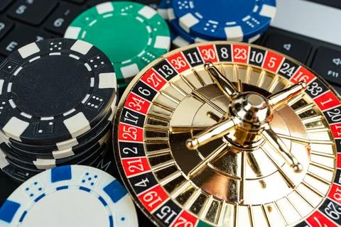 Image of a roulette wheel with casino chips, conveying gambling, risk, and .. Stock Photos