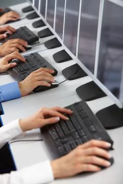 Image of row of human hands typing in computer classroom Stock Photos