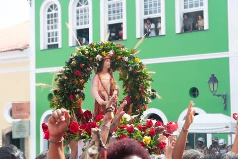 Image of Saint Barbara being held by a devotee amidst a crowd during a fest.. Stock Photos