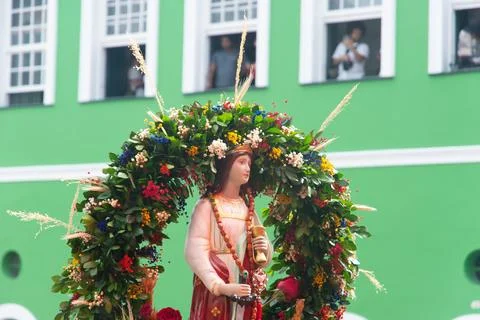 Image of Saint Barbara being held by a devotee amidst a crowd during a fest.. Stock Photos