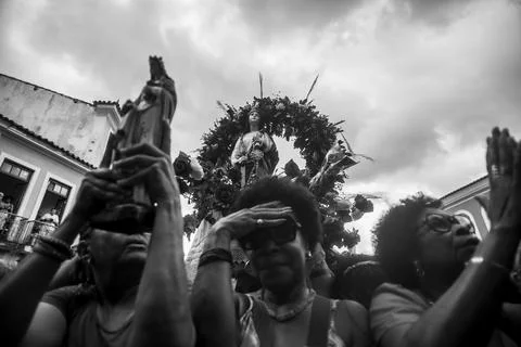 Image of Saint Barbara being held by a devotee amidst a crowd during a fest.. Stock Photos