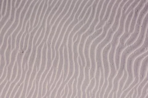 The image is of a sandy beach with a wave pattern Stock Photos
