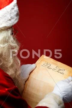 Image of santa claus reading christmas letter in his hands Stock Photos