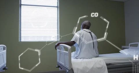 Image of scientific data processing over african american man in hospital bed Foto stock