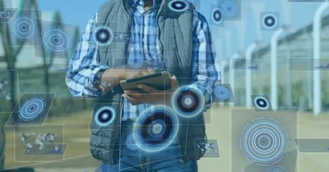 Image of scope scanning and data processing on screens over man using tablet 스톡 사진