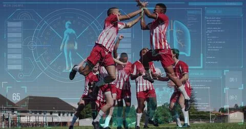 Image of screen with biological data over diverse male soccer players jumping Foto stock