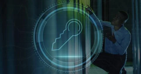 Image of security key icon over african american male engineer using tablet.. Stock Photos