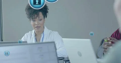 Image of security padlock data processing over diverse doctors in office Stock Photos