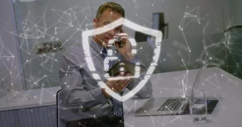 Image of security padlock icon over caucasian businessman talking on smartphone Foto stock