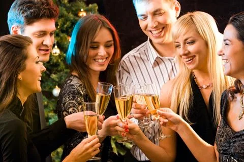 Image of several attractive friends making a clink of champagne bocals Stock Photos