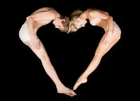 Image of shape of heart made up by two lovers over black background Fotos Stock