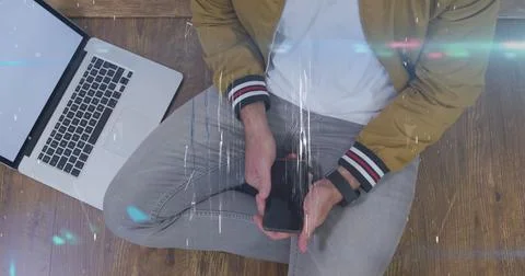 Image of shapes over midsection of caucasian man using laptop and smartphone Stock Photos