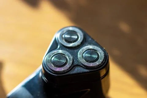 This image showcases a close up of a shaver that features three sharp blades Stock Photos