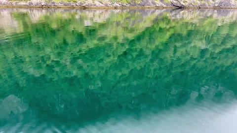 The image showcases crystal-clear waters reflecting the surrounding landscape Video stock 313949467