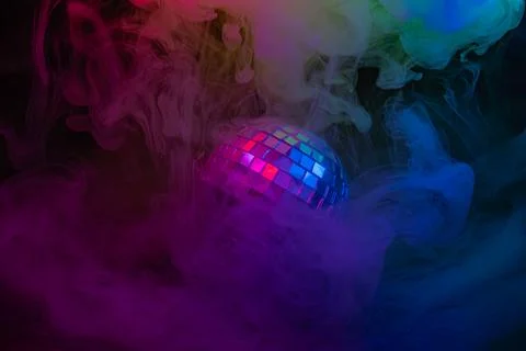 Image showcases a disco ball against colorful, nebulous effects with an ene.. Stock Photos