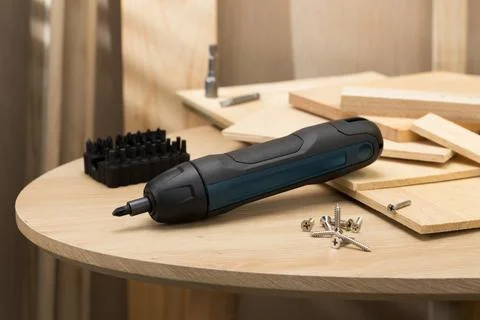The image showcases a mini handheld cordless screwdriver. Stock Photos