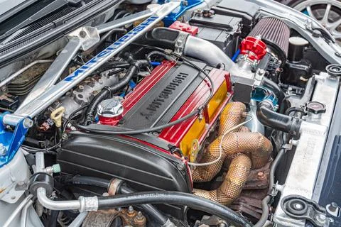Image showcases an open engine bay of a high-performance sports car, featurin Stock Photos