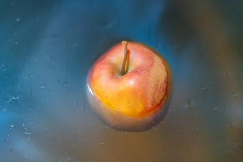 An image showcases a prepared apple for baking, with a wooden skewer, on a .. Stock Photos