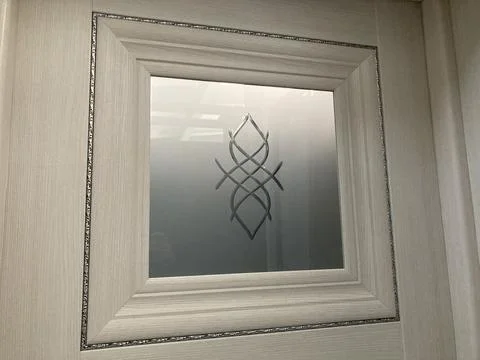 Image shows an abstract artwork on a wall, framed in dark wood, with swirling Stock Photos