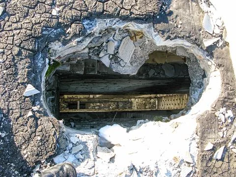 Image shows aftermath of explosion or destruction, featuring a large hole i.. Foto stock