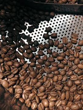 The image shows a bunch of coffee beans being roasted Stock Photos