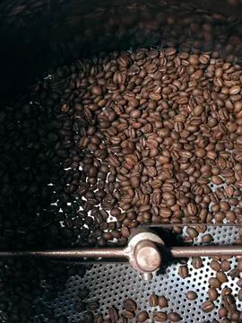 The image shows a bunch of coffee beans being roasted Stock Photos