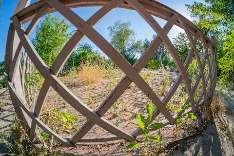 Image shows an off-center, tilted circular wooden frame with a lattice patt.. Stock Photos
