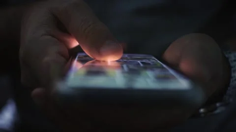 The image shows a close-up of hands holding a smartphone. Stock Footage 318219112