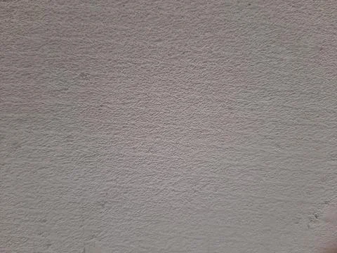This image shows a close-up of a rough, textured wall surface, perfect for de Stock Photos