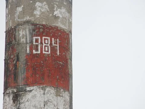 Image shows a close-up of a tower or pole from 1984, with 1984 painted on a r Stock Photos