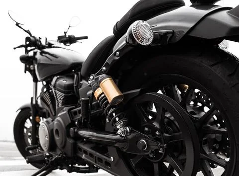 The image shows a close-up view of a black motorcycle, highlighting its rear  Stock Photos