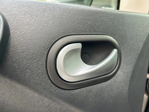 The image shows a close-up view of a car door handle located inside a vehicle Photos