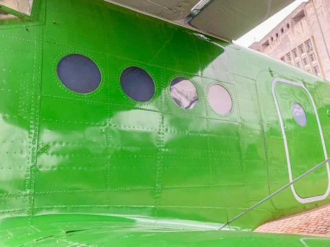 Image shows a close-up view of a dark green aircraft fuselage, with three win 스톡 사진