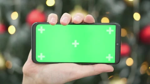 The image shows a closeup of a hand gripping a modern smartphone with a vibrant Stock Footage 317021864