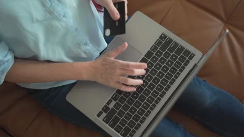 The image shows hands typing on a laptop while holding a credit card Stock Footage 289967298