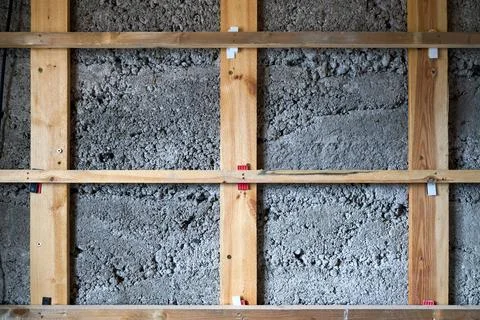The image shows an interior wall covered with a grid-like wooden framing stru Stock Photos