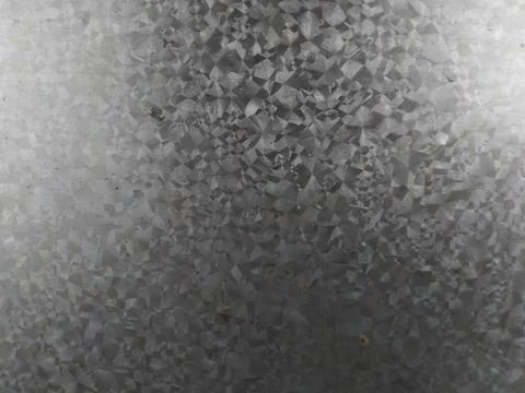 The image shows a metal surface with a repeating diamond pattern and a textur Stock Photos