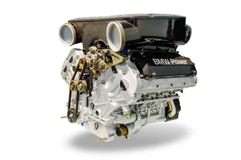 The image shows a modern car engine isolated on a white background. The engin Stock Photos