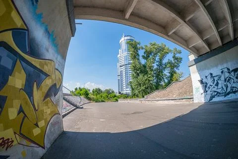 Image shows a multi-story parking garage with graffiti and greenery, showcasi Stock Photos