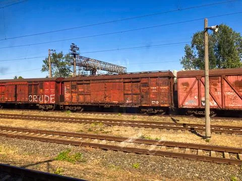 Image shows an old, rusty red train car labeled WASHOUT 2075 on a railroad sc Photos