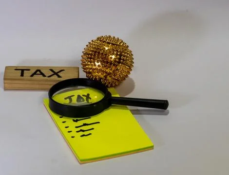 The image shows a setup of items typically used for tax calculations. Stock Photos