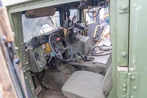 Image shows side view of a worn, utilitarian military vehicle interior with.. Stock Photos