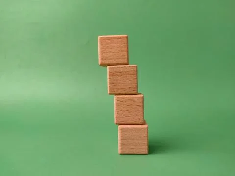 The image shows a stack of four natural wooden blocks Stock Photos
