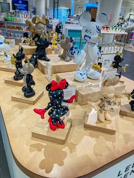 The image shows a vibrant display table with Disney merchandise, mainly Minni Stock Photos