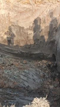 The image shows a wall under construction, with visible layers of concrete .. Stock Photos