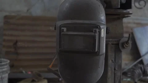 The image shows a welding helmet placed in a blacksmith shop, ready for use Stock Footage 293180862