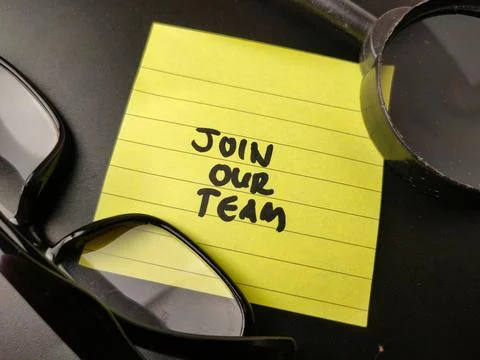 The image shows a yellow sticky note with the words JOIN OUR TEAM written o.. Stock Photos
